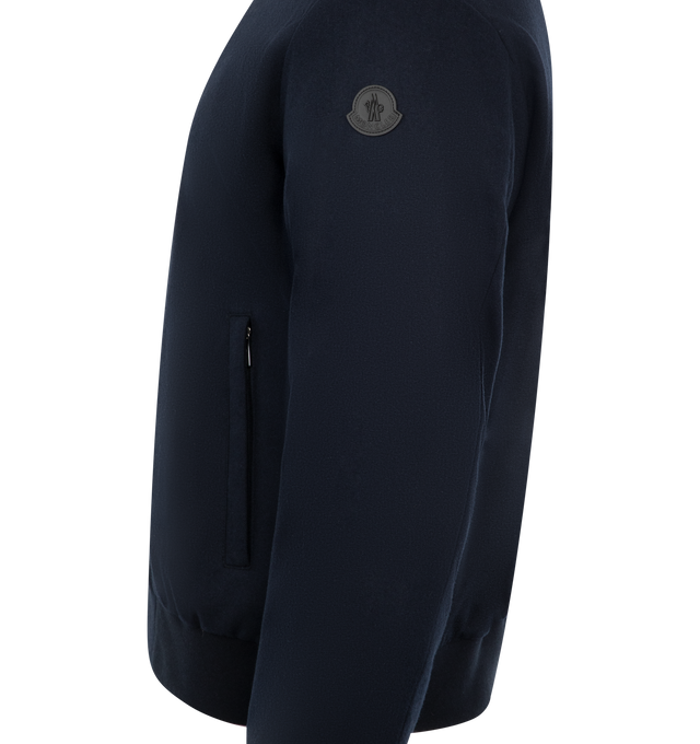 Image 3 of 4 - NAVY - Moncler Villerest Bomber has a baseball collar, a 2-way zip front, side pockets, band-finished cuffs and hem, and a leather logo patch. Down and feather fill. Nylon, polyamide, cashmere, and leather. Made in Romania.