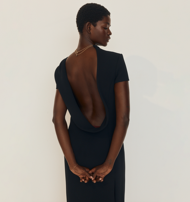 Image 3 of 5 - BLACK - KHAITE Iryl Dress featuring a fluid, open-back dress, architectural structure, softly contoured side panels, a back slit, concealed zipper closure and lined in soft silk habotai. 100% polyester.