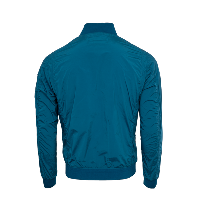 Image 2 of 3 - BLUE - C.P. COMPANY Nycra-R Bomber Jacket featuring rib knit band collar, hem, and cuffs, two-way zip closure, flap pockets, zip pocket, acetate lens and zip pocket at sleeve, unlined and logo-engraved black hardware. 92% polyamide, 8% spandex. Made in Bulgaria. 