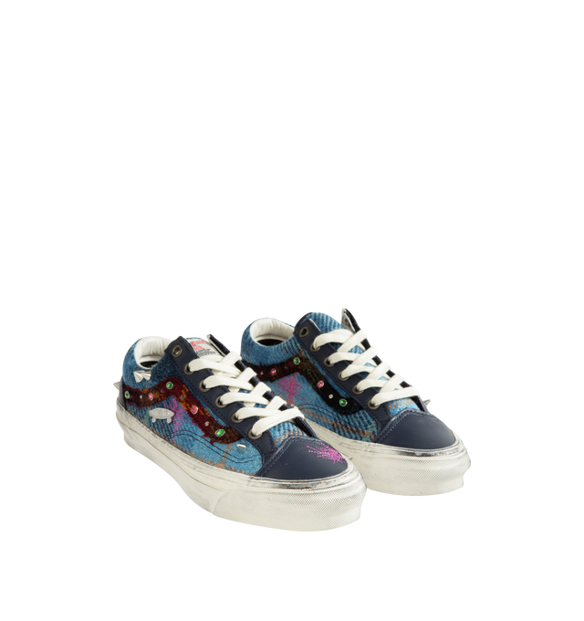 Image 2 of 3 - BLUE - Vans Unisex Premium Old Skool 36 Harris Tweed Sneakers are crafted from Harris Tweed woven from 100% virgin wool and feature the iconic low-top silhouette, lace-up closure, and contrast stitching. Designed with jewel, pin, and stud embellishments, a subtly distressed finish, and a padded collar. Main Material: Harris Tweed 100% Virgin Wool. Outsole: Rubber. *Unisex style in men's sizing.