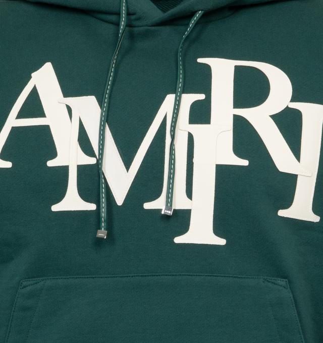 Image 3 of 3 - GREEN - AMIRI Staggered Logo Hoodie featuring slouchy hood, drop shoulder, front pouch pocket, straight hem and embroidered logo at the chest and back. 100% cotton.  