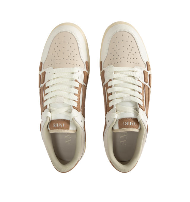 Image 5 of 5 - BROWN - AMIRI Skel Top Low Sneakers featuring low-top grained leather and cotton twill sneakers, perforations at toe, logo patch at padded tongue, padded collar, graphic appliqus at sides and logo printed at heel tab. Upper: leather, textile. Sole: rubber.