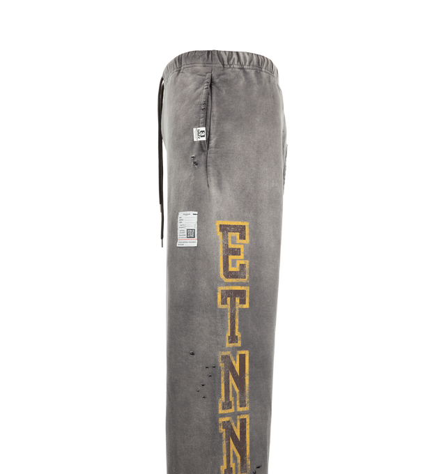 Image 3 of 3 - GREY - Maison Mihara Yasuhiro Men's Sun Faded Like Sweat Pants are crafted from cotton and feature a sun-faded appearance with bleached and distressed detailing, a college-inspired graphic print, and side pockets. Main Material: 100% Cotton. Made in Japan.