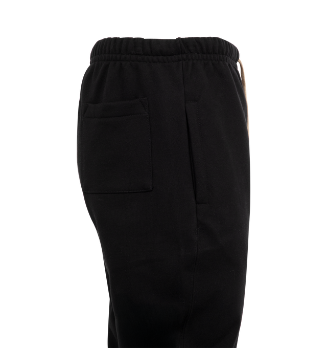 Image 3 of 3 - BLACK - MERZ B. SCHWANEN Loopwheeled Sweatpants Heavy featuring narrow tapered leg, slit with button facing, form-stable waistband made of ribbed fabric at the bottom, heavy, grippy and slightly irregular surface structure, side pockets, patch back pocket, integrated front slit with fabric underlap, genuine mother-of-pearl buttons and drawstring with natural cotton ribbon. 100% cotton. Made in Germany.
