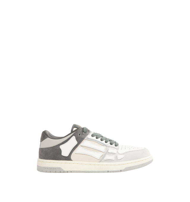 Image 1 of 5 - GREY - AMIRI Distressed Skel-Top Low Sneakers featuring appliqus throughout, perforated detailing at toe, lace-up closure, logo patch at padded tongue, padded collar, logo embossed at heel tab and treaded rubber sole. Upper: synthetic, leather. Sole: rubber.