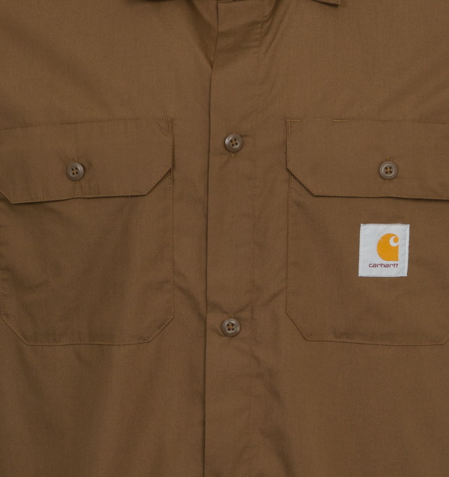 Image 3 of 3 - BROWN - CARHARTT WIP Craft Shirt featuring lightweight polycotton poplin blend, back pleat, loose fit, two chest pockets with a flap and button closure and Carhartt WIP's signature woven Square Label. 65% polyester, 35% cotton. 
