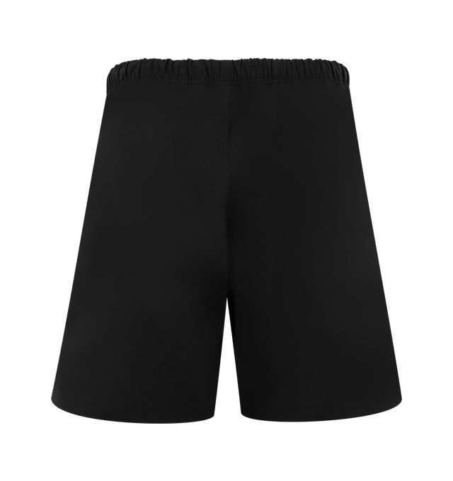 Image 2 of 3 - BLACK - FEAR OF GOD ESSENTIALS Active Trace Relaxed Short featuring a perforated lining for enhanced breathability, a voluminous, elongated silhouette, 3M Embroidered Essentials Active Trace logo divided across both legs, Essentials signature label is positioned at the center front, side pockets, leg slits and an encased elastic waistband with drawstrings. 100% polyester.