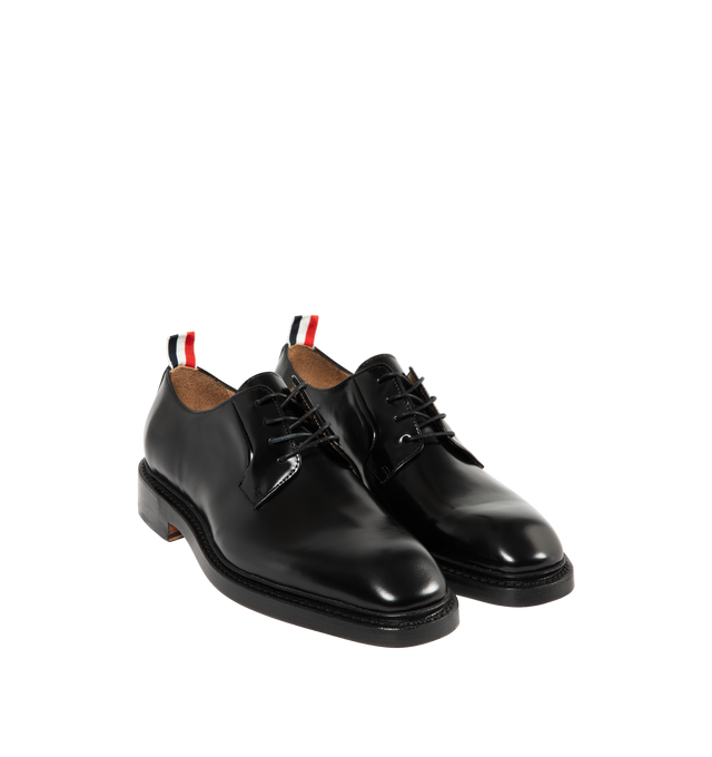 Image 2 of 4 - BLACK - THOM BROWNE Soft Spazzolatio Blucher Shoe featuring soft spazzolato leather with a high-shine finish, nipped toe, lace-up closure, Goodyear-welted leather sole with rubber heel insert, metal taps on heels and signature striped grosgrain loop tab. 100% calf leather. Made in Italy.