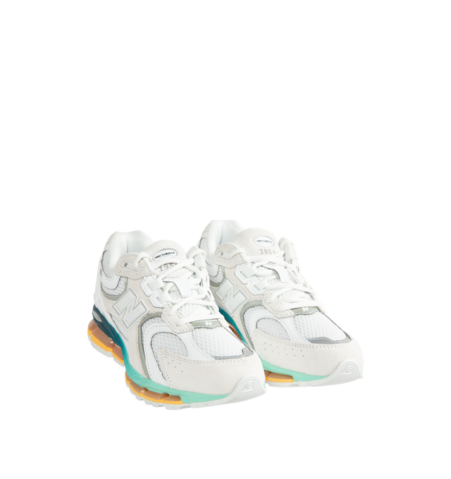 Image 2 of 5 - WHITE - New Balance Unisex 1954R Sneakers feature a Reflection, White, and Bright Mint upper inspired by the 2002 and 1906 models, combining breathable mesh with synthetic and pig suede overlays. ABZORB midsole cushioning absorbs impact through cushioning and compression resistance, while a traditional lace-up closure provides an adjustable fit. Upper: Synthetic, Mesh, and Pig Suede. Closure: Lace-Up. *Unisex style in men's sizing.
