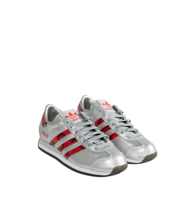 Image 2 of 5 - SILVER - ADIDAS Country Japan Sneakers are a lace-up retro style with metallic leather upper with snakeskin-patterned detail on the heel tab and signature 3-Stripes, EVA midsoles, and rubber outsoles.