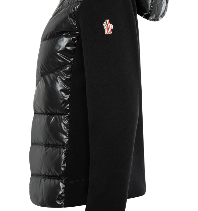 Image 3 of 3 - BLACK - MONCLER GRENOBLE Padded Zip-Up Hoodie featuring stretch fleece, down-filled nylon laqu front and hood, nylon lining, adjustable hood and YKK AquaGuard Highly Water Resistant zipper closure. 93% polyester, 7% elastane/spandex. 100% polyamide/nylon. Padding: 90% down, 10% feather.