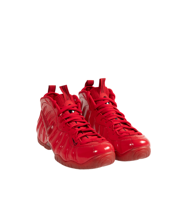 Image 2 of 5 - RED - NIKE Air Foamposite Pro Sneaker featuring Foamposite upper that molds to your foot, full-length and heel Zoom Air cushioning, foam midsole and rubber outsole with herringbone tread.