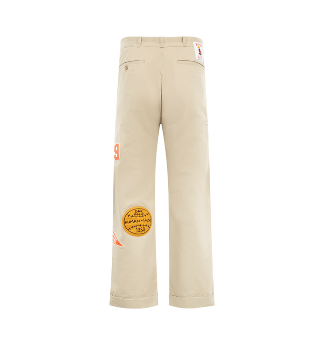 Image 2 of 4 - NEUTRAL - HUMAN MADE College Pants featuring high-density cotton chino cloth, relaxed silhouette, zip fly, brand message printed inside the back waist, bear label above one back pocket, heart button on the other, two side and back pockets and double roll-up cuff. 100% cotton. Made in Japan.