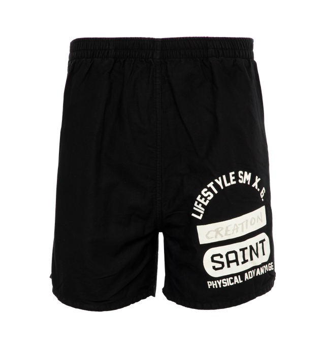 Image 1 of 4 - BLACK - SAINT MICHAEL Easy Shorts featuring elastic waist, screen print on leg, side slit pockets and back pocket. 100% cotton.  