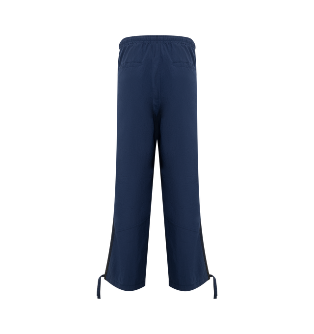 Image 2 of 2 - BLUE - RHUDE Track Pants featuring concealed drawstring at elasticized waistband, four-pocket styling, logo printed at front, tucks at knees and drawstring at elasticized cuffs. Made in United States.