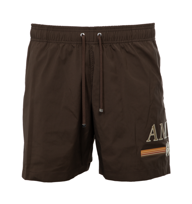 Image 1 of 4 - BROWN - AMIRI Swimshort featuring a gradient bar logo at the left thigh, crafted with side seam pockets, back flap pocket, elastic waist and drawcord. Made in Italy.  90% POLYESTER 10% SPANDEX. 