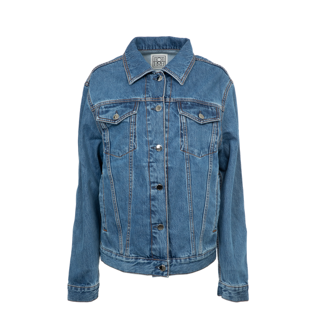 Image 1 of 3 - BLUE - TOTEME Classic Denim Jacket featuring a boxy silhouette finished with silver-tone buttons, flap and welt pockets, and a back monogram leather patch. 100% cotton organic. 