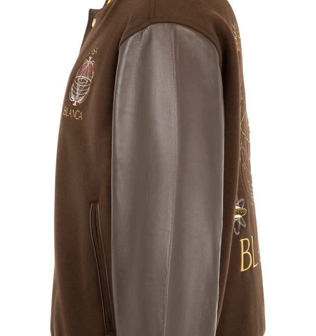 Image 3 of 3 - BROWN - Casablanca Men's Brown Celestial Pyramid Wool & Leather Varsity Jacket is crafted from an Italian wool with lamb nappa leather sleeves and embroidery. Designed in a relaxed silhouette for cold-weather layering, this varsity-inspired jacket is detailed with a button-front closure, branded snap buttons, slanted welt pockets, and classic rib-knit collar, cuffs, and hem finished with yellow stripe accents. Fully lined for comfort, it combines premium materials with Casablanca's distinctiv