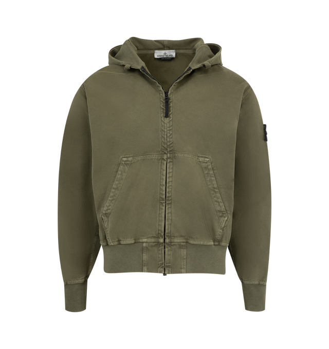 Image 1 of 3 - GREEN - STONE ISLAND Hoodie Sweater featuring hood with ribbed cotton lining around contour, fixed drawstring, ribbed cotton inserts at shoulders, under armholes, and on sides, hand patch pockets with slanted entrance, Stone Island badge on left sleeve, ribbed cotton cuffs and bottom band and oversized fit. 100% cotton.