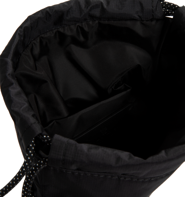 Image 3 of 3 - BLACK - MONCLER Makaio Drawstring Bag featuring water-repellent nylon lining, leather trim, climbing cord drawstring closure, outer pocket, inner media pocket, climbing cord shoulder strap and silicone logo patch. L 18 cm x H 23 cm x W 2 cm. 100% polyamide/nylon. 