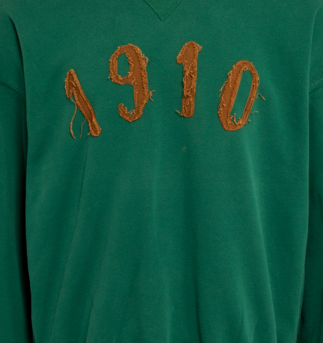Image 3 of 4 - GREEN - This forest green upcycled vintage sweatshirt features "1910" applique at the front, Transnomadica label at the back.  80% cotton / 20% polyester. Measurements: 25 inches in length from neckline to front hem, 27 inches from shoulder-to-shoulder, 27 inches from armpit-to-armpit, 23 inches from top sleeve seam to top of wrist with size XXL on its original vintage label.This collection of vintage sweatshirts, exclusively for 1910 at Hirshleifers, each featuring a hand-crafted 1910 appl 