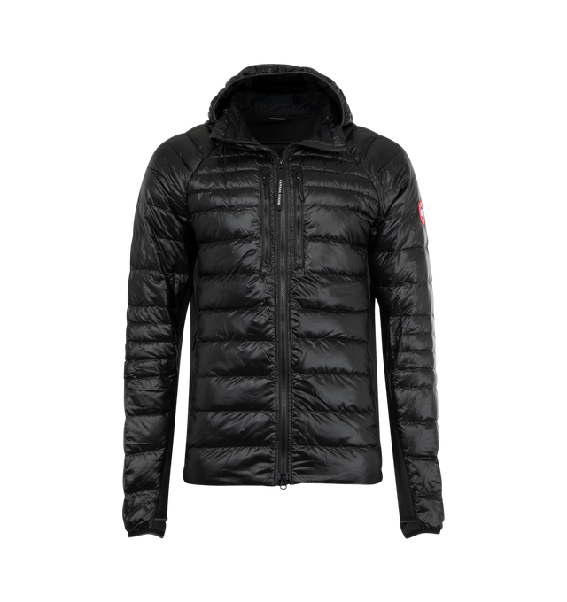 Image 1 of 3 - BLACK - CANADA GOOSE HyBridge Lite Hoody featuring down-filled hood with stretch binding, storm flap underneath two-way zipper, cuffs with discreet thumbhole construction, tricot-lined chin guard, two exterior mesh-lined hand pockets with zipper closures, two interior lower drop-in pockets and packable into wearer's exterior right pocket. 100% recycled polyamide. Fill: 90% down, 10% feathers.