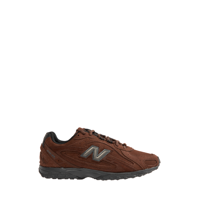 Image 1 of 5 - BROWN - New Balance 204L Sneakers feature an interpretation of 2000s running-inspired style, blending the slim proportions of vintage 1970s running shoes with modern technical detailing. Crafted with a premium suede upper, this low-profile silhouette draws inspiration from iconic New Balance designs past and present, resulting in a look that feels both familiar and contemporary. Distinctive arced overlays, screen-printed saddle graphics, and a double-stacked suede "N" logo add visual depth,