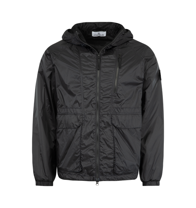 Image 1 of 3 - BLACK - STONE ISLAND featuring hood with visor and elasticated drawcord at contour and back, shaped front yoke with raglan sleeves, angled chest pocket with zipper, bellows hand pockets with flap and concealed double snap, vents on back, Stone Island badge on left sleeve, elasticated cuffs, elasticated drawcord at hem and two-way zipper fastening. 100% polyamide/nylon.