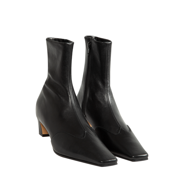 Image 2 of 4 - BLACK - Khaite Women's Nevada Stretch Low Boot featuring mid-calf urban cowboy boot, calfskin wingtip traced by tonal topstitching, pointed toe and side zipper closure. Heel Height: 1.8 in. 100% lambskin. Made in Italy.