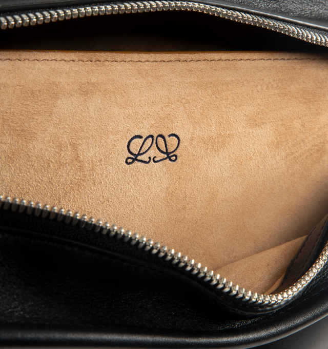 Image 4 of 4 - BLACK - LOEWE Amazona Medium 180 Bag in soft calfskin featuring a relaxed silhouette with a single toron top handle, designed to be carried open, while a concealed closure secures the main compartment, removable shoulder and crossbody straps, zip closure with two leather zip pullers, two compartments, main compartment closed with magnetic closure, internal flat pocket, suede lining and embossed logo. Soft calfskin. Made in Spain.
