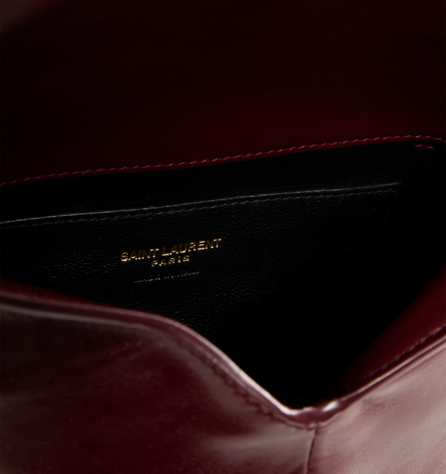 Image 3 of 3 - RED - SAINT LAURENT Chain Pouch featuring shiny calfskin, decorated with the CASSANDRE, may be carried by hand as a clutch or on the shoulder, leather lining, bronze-tone hardware, magnetic closure and one card slot. 7.5" x 4.7" x 1.2". Calfskin. Made in Italy.
