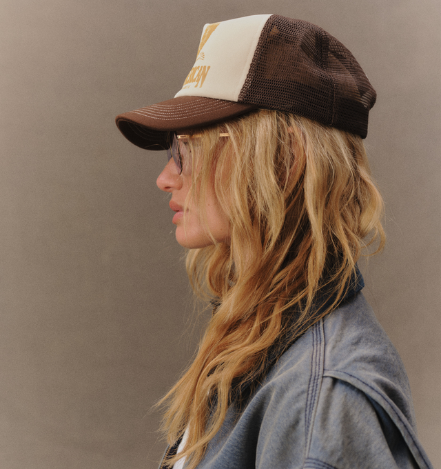 Image 6 of 7 - BROWN - Cherry LA Golden Eagle Trucker Hat is crafted from polyester and features a classic trucker silhouette with a screen-printed Golden Eagle graphic at the front and embroidered detailing at the back. Main Material: Polyester. Fit: Adjustable. Closure: Plastic Snapback Closure. Made in Los Angeles, California.