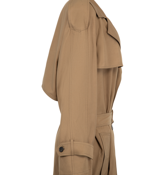 Image 3 of 3 - BROWN - Saint Laurent Womens Large Belted Trench Coat is crafted from certified cotton and features an ulster collar, raglan sleeves, and front and back storm flaps. Designed with a double-breasted four-button closure, padded shoulders, buttoned epaulets, two-button tab cuffs, two front welt pockets, an adjustable and detachable belt, and a single back vent. Main Material: Certified Cotton. Made in Italy.