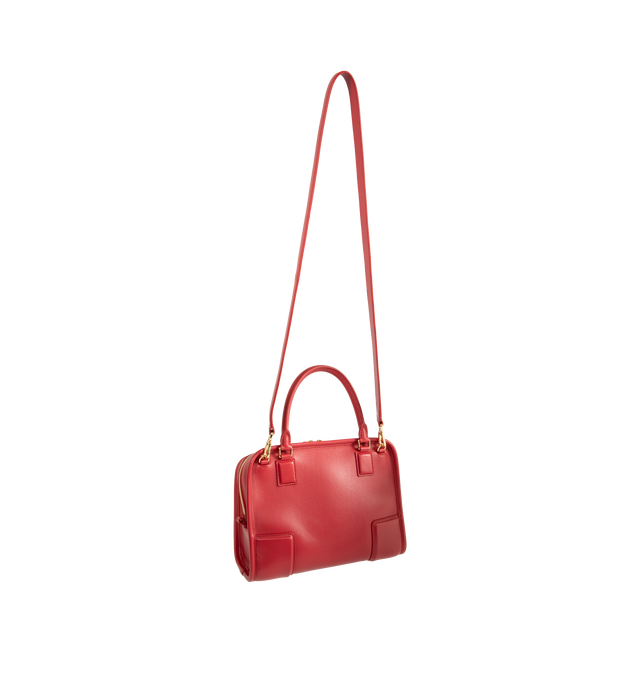 Image 3 of 5 - RED - Loewe Small Amazona 180 Bag in leather features a relaxed silhouette anchored by a single toron top handle, designed to be carried open, while a concealed closure secures the main compartment, three carry options: short handle, removable shoulder strap and crossbody, zip closure with two leather zip pullers, two compartments, main compartment closed with magnetic closure, internal flat pocket, left side d-ring for customization, nappa lambskin lining, and embossed double L branding. Lea