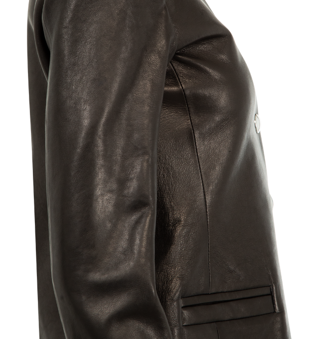 Image 4 of 4 - BLACK - KHAITE Nara Jacket featuring a collarless, high-necked jacket shaped by soft peplum contouring, reinforced shoulder pads, single-breasted silhouette, cropped fit, faux pockets and cupro twill lining. 100% lamb.