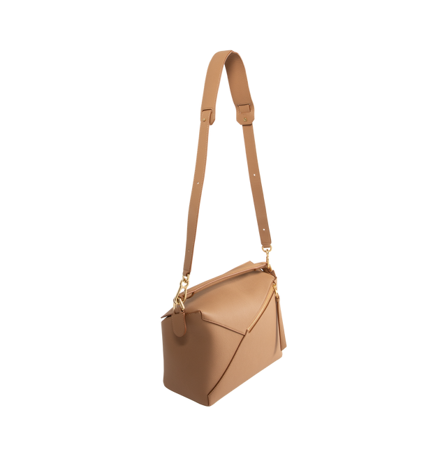 Image 2 of 3 - BROWN - LOEWE Medium Puzzle Edge Bag in soft grained calfskin featuring shoulder, crossbody or hand carry, detachable and adjustable strap, zip closure with calfskin pull, one external zip rear pocket, two internal slip pockets, herringbone cotton canvas lining and embossed Anagram. 7.7 x 11.4 x 5.5 inches. Soft grained calf. Made in Spain.
