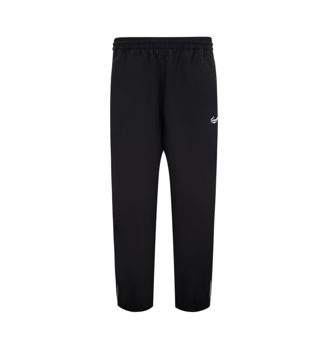 Image 1 of 3 - BLACK - WILLY CHAVARRIA Bad Boy Track Pant featuring a relaxed, easy fit, side pockets, elastic waistband and hems, lightweight, stacked double CHAVARRIA logos at the left pocket and double stripes down legs. 100% nylon.