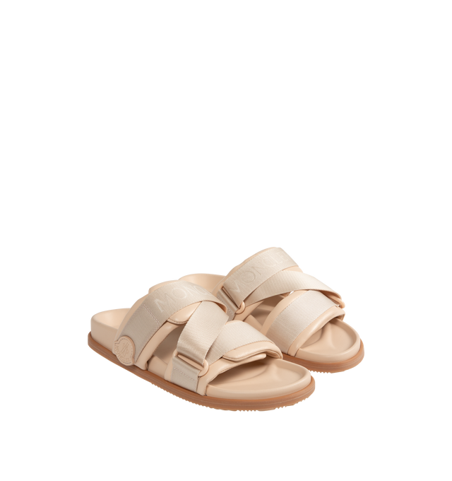 Image 2 of 4 - NEUTRAL - MONCLER Mon Summer Leather Crisscross Sandals featuring crisscross logo-stamped polyester strap, flat heel, dual band upper, slip-on style, molded footbed, rubber outsole. Lining: leather. Made in Italy.
