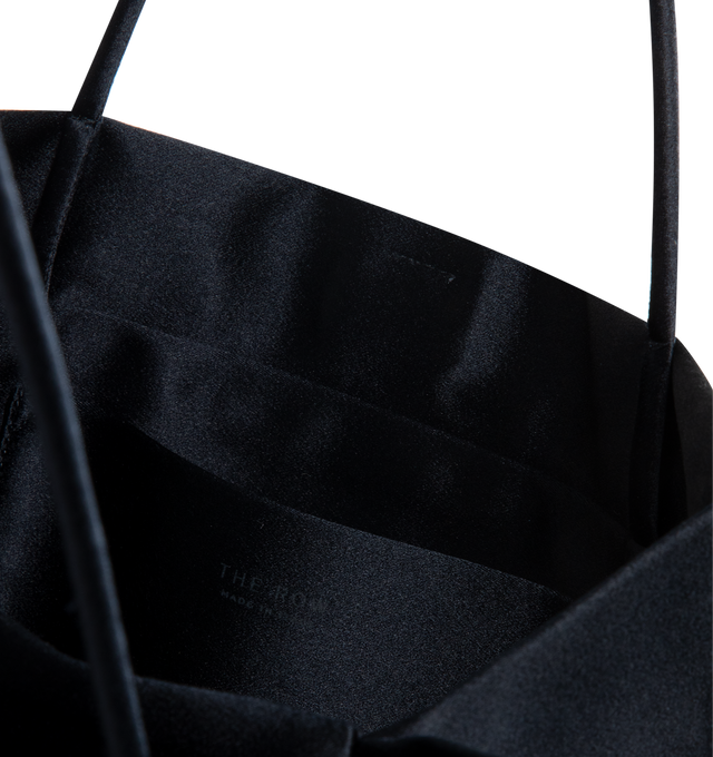 Image 3 of 3 - NAVY - The Row Cecily Top Handle Bag is crafted from glossy nappa lambskin leather. Features slim tubular top handles, an accordion base, and a lambskin leather-lined interior. Main Material: 100% Lambskin Leather; Lining: 100% Lambskin Leather. Dimensions: 8.86" W x 7.16" H x 0.78" D. Made in Italy.