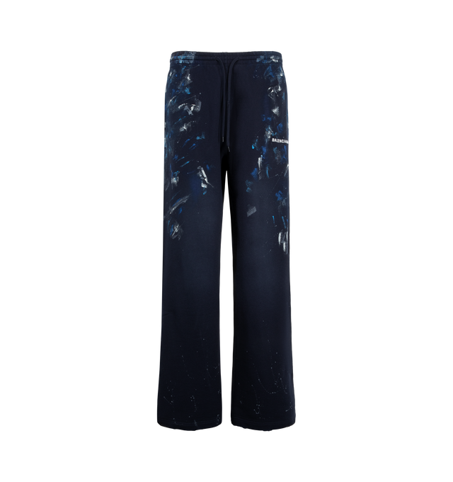 Image 1 of 3 - NAVY - Balenciaga Men's Paint Splatter Baggy Sweatpants are crafted from faded black dry cotton fleece and feature a mid-rise, oversized silhouette. An elasticated drawstring waistband, and Balenciaga artwork at the front complete the design. Main Material: 100% Cotton. Pocket Lining: 100% Cotton. Made in Portugal.