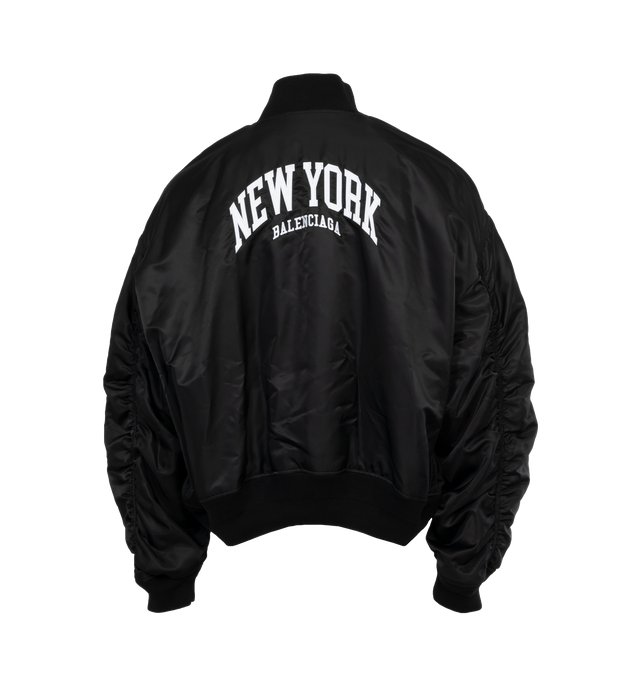 BLACK - BALENCIAGA NY Varsity Jacket featuring light nylon, large fit, snap closure, 2 snap flap pockets at front, ribbed trims and New York with logo embroidered at chest and back. 100% polyamide. Made in Italy. 
