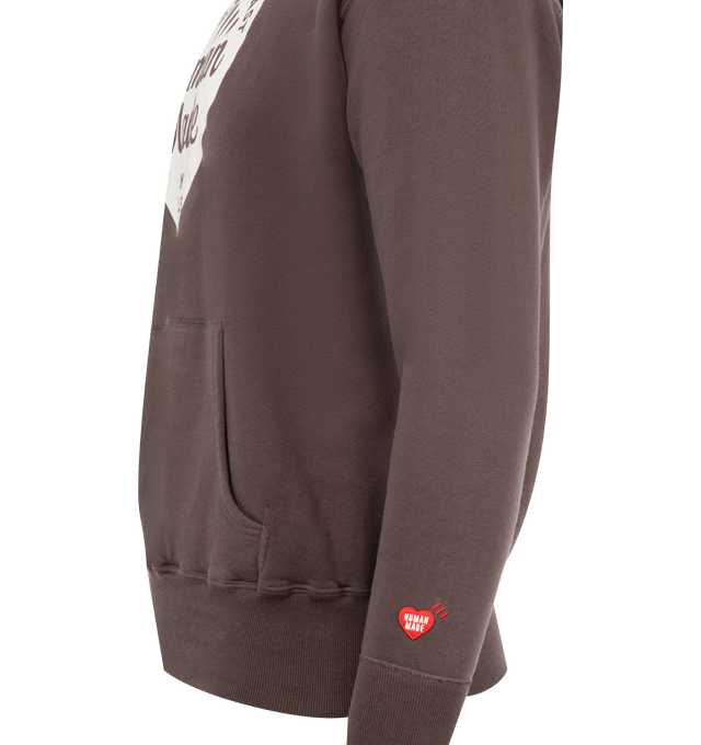 Image 3 of 3 - BROWN - HUMAN MADE Tsuriami Heart Hoodie featuring fixed hood, kangaroo pouch pocket, extended trims, printed branding and woven brand patch. 100% cotton.