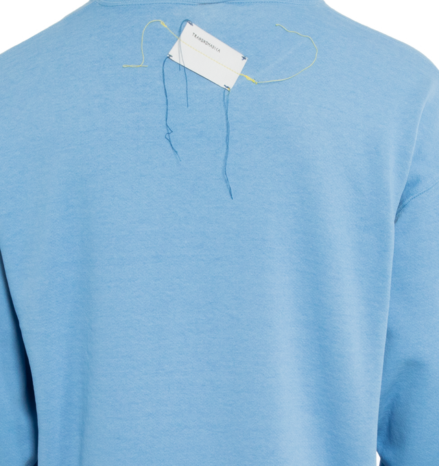 Image 4 of 4 - BLUE - This powder blue upcycled vintage sweatshirt features "1910" applique at the front and Transnomadica label at the back. 50% cotton / 50% polyester with the size XL on its original vintage label. Measurements: 23 inches in length from neckline to front hem, 25 inches from shoulder-to-shoulder, 25 inches from armpit-to-armpit, 22 inches from top sleeve seam to top of wrist.This collection of vintage sweatshirts, exclusively for 1910 at Hirshleifers, each featuring a hand-crafted 1910 a 