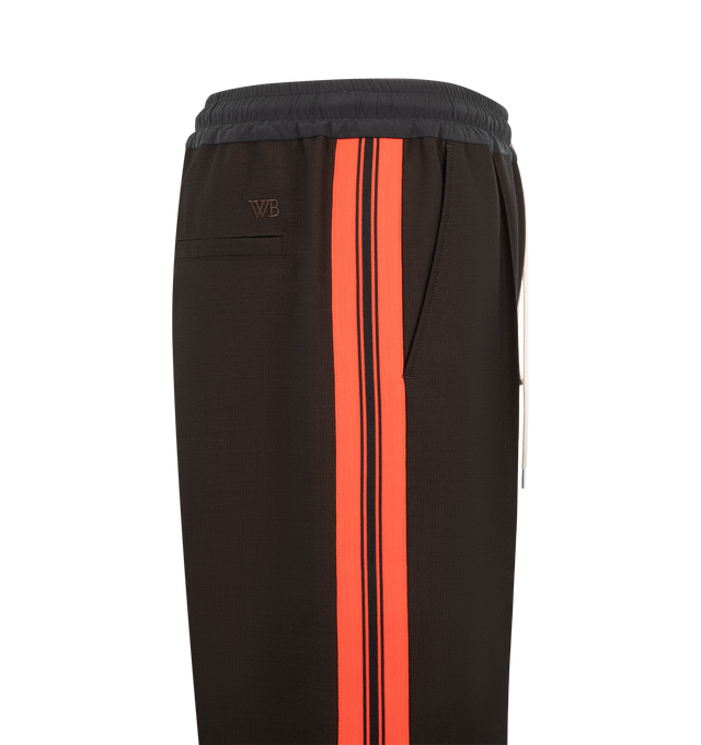 Image 3 of 3 - BROWN - Wales Bonner Men's Energy Trouser is crafted from crespo wool and silk and features a refined tailored silhouette with a concealed drawstring elasticized waistband for elevated comfort. Detailed with front pleats, slip pockets, contrast ribbing along the side legs, and an embroidered WB logo at the back, these trousers balance classic tailoring with the brand's distinctive sportswear influences. Main Material: 100% Virgin Wool. Trim 1: 100% Silk. Trim 2: 100% Polyester. Pocket Lining: