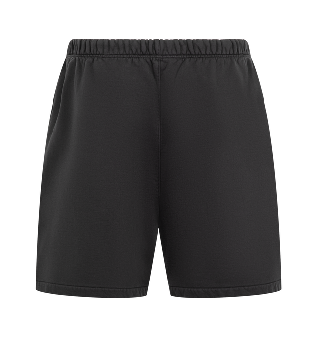 Image 2 of 3 - BLACK - Fear of God ESSENTIALS Men's Classic Sweatshort is crafted from pigment-dyed heavyweight 480 GSM cotton-blend fleece and features a relaxed, slouchy silhouette inspired by vintage athletic wear. Designed with a FOG puff-print graphic at the leg, this elevated everyday short is finished with an encased elastic waistband, heavyweight drawstring, side-seam pockets, and a signature Essentials label at the center front. Main Material: 80% Cotton, 20% Polyester Fleece, 480 GSM.