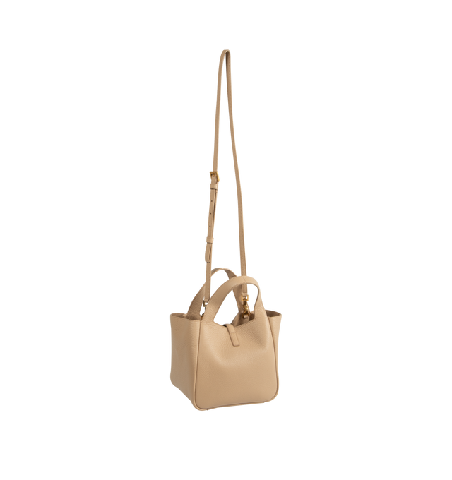 Image 2 of 3 - NEUTRAL - Saint Laurent Women's Le 5 7 Baby Bea Bag is crafted from deerskin and features the signature CASSANDRE hook closure, bronze-tone hardware, and a tonal suede lining. A compact interpretation of the iconic Le 5 7 Bea silhouette, this versatile bag can be carried by hand with the top handle or worn crossbody with the adjustable and detachable strap. Dimensions: 18 x 15 x 13 cm / 7.1 x 5.9 x 5.1 in. Handle Drop: 10 cm / 3.9 in. Strap Drop: 55.5 cm / 21.9 in. Fits a large phone, card