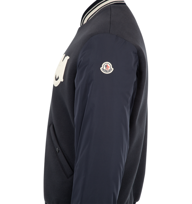 Image 4 of 4 - NAVY - MONCLER Vennes Reversible Down Bomber Jacket featuring cotton fleece, longue saison lining, reversible, micro soft back and arms, zipper closure, pockets with snap button closure, cuffs and hem with striped rib knit trim and terry cloth monogram patch.