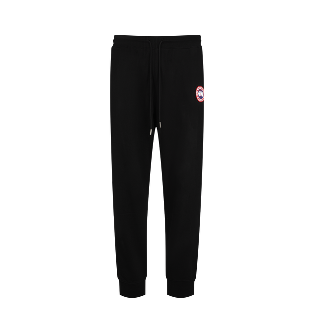 Image 1 of 3 - BLACK - Canada Goose Men's Loon Joggers are crafted from lightweight organic cotton terry with a tight-knit construction, breathable feel, and streamlined finish. Designed for elevated everyday comfort, these designer sweatpants feature an adjustable drawcord waist, two jersey-lined welt pockets, and rib-knit cuffs for a secure fit. Main Material: 100% Organic Cotton. Fabric: Lightweight Cotton Terry. Waist: Drawcord. Pockets: Two Jersey-Lined Welt Pockets. Details: Rib-Knit Cuffs, Classic Ca
