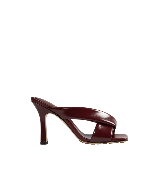 Image 1 of 4 - RED - BOTTEGA VENETA Riva Mule featuring shiny calfskin with padded tubular straps, twisted design and rubber injected leather outsole. Calfskin. Lining: lambskin. Heel: 3.5. Made in Italy.