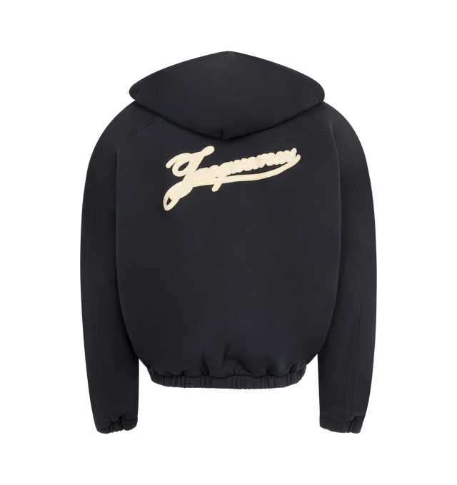 Image 2 of 3 - BLACK - JACQUEMUS Torneo Hoodie featuring rosemary label zipped hoodie, oversized fit, brushed cotton fleece, hood with drawstrings, square metal tips with engraving, drawstring hood with circle and square tips, double-sided zipper, buttoned welt pocket with "J" loop, embroidered Rosemary logo patch, side-seam pockets, elasticated cuffs and hem, embroidered logo patch on the back and fully lined. 100% cotton. Made in Portugal.